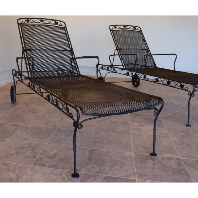 A refined pair of mid-century wrought iron chaise lounges attributed to Woodard Furniture Company, circa 1955–1965. These...
