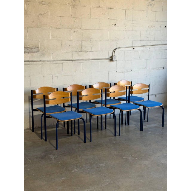 This striking set of eight stacking chairs features molded wooden backrests and vibrant blue upholstered seats paired with...
