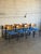 This striking set of eight stacking chairs features molded wooden backrests and vibrant blue upholstered seats paired with...