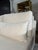 White fabric customer loveseat with a clean, modern look that brightens any living space. The piece features comfortable...
