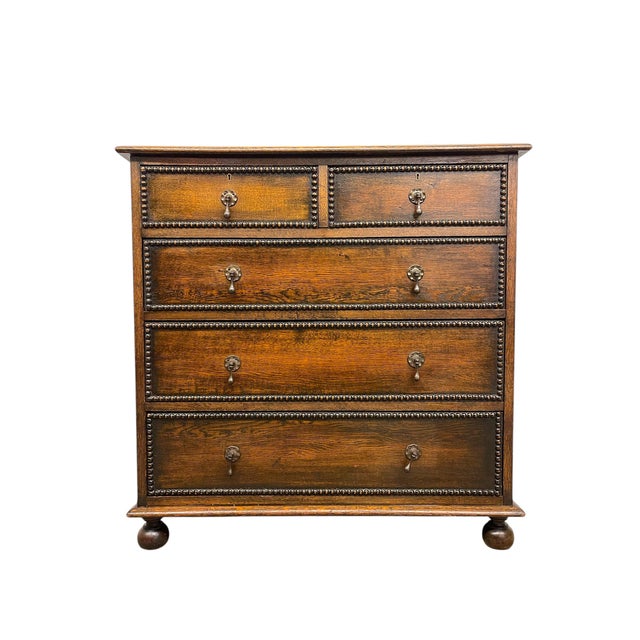 This early 20th-century English chest of drawers is attributed to Hansford Bros., Cabinet Makers and Upholsterers,based on...