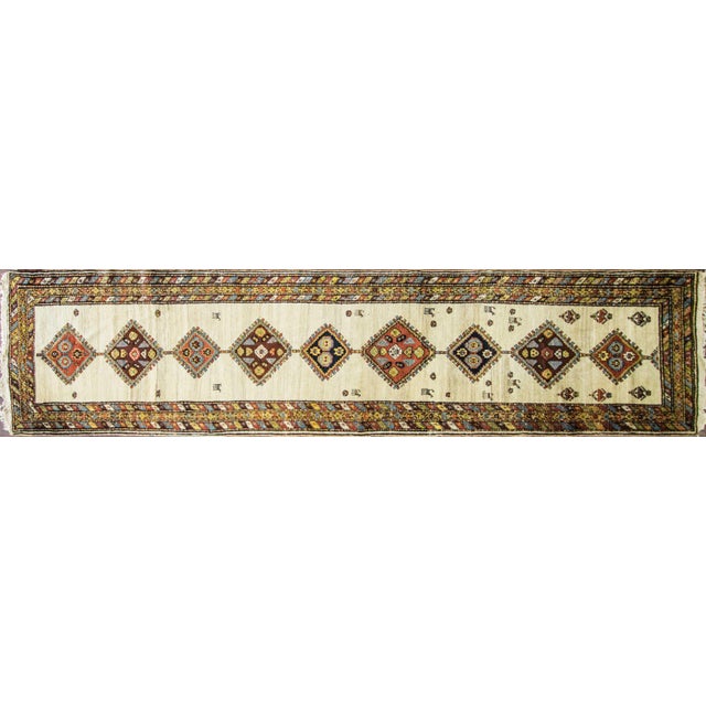 This elegant Antique Caucasian Runner, woven around 1900, is a beautiful example of the refined tribal weaving traditions...