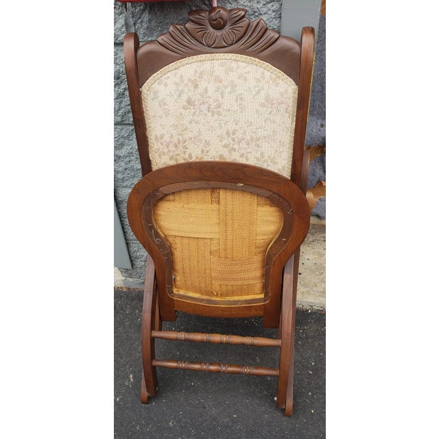 An Early 20th century Victorian Style carved Walnut and Upholstered rocking chair.