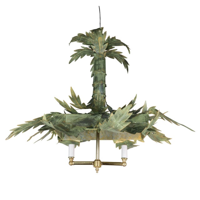 The chandelier is handcrafted with a metal frame, adorned with intricately layered palm leaves and realistically textured...