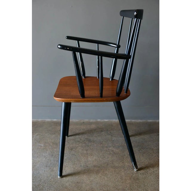 Danish spindle back arm chair by Thomas Harlev for Farstrup, 1960. Single dining chair with age appropriate wear but in...