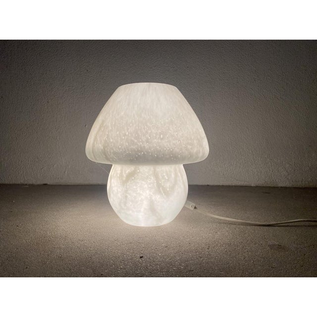 This unique table lamp in mushroom design from the 1970s was designed by Peill & Putzler. It consists of mouth -blown...
