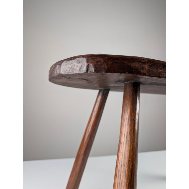 This bench was hand-carved from a single thick slab of dark hardwood in the 1940s, reflecting the wabi-sabi sensibility...