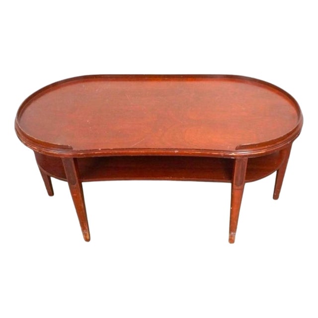 Merman Regency Style Mahogany six legs Tiered Kidney Coffee Table, Circa 1940s Measures 36" in width, 18" in height and...