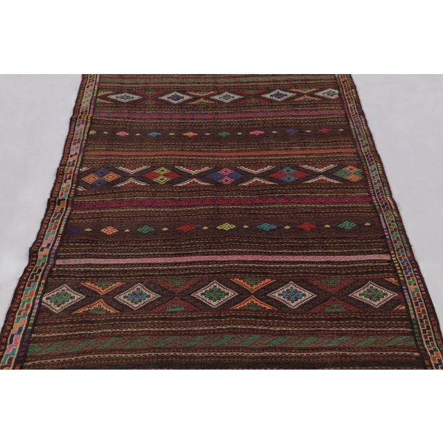 Made with handwoven wool circa 1950-1960, this 4x6 vintage Kilim, originating from the Larkhabi region of Afghanistan, is...