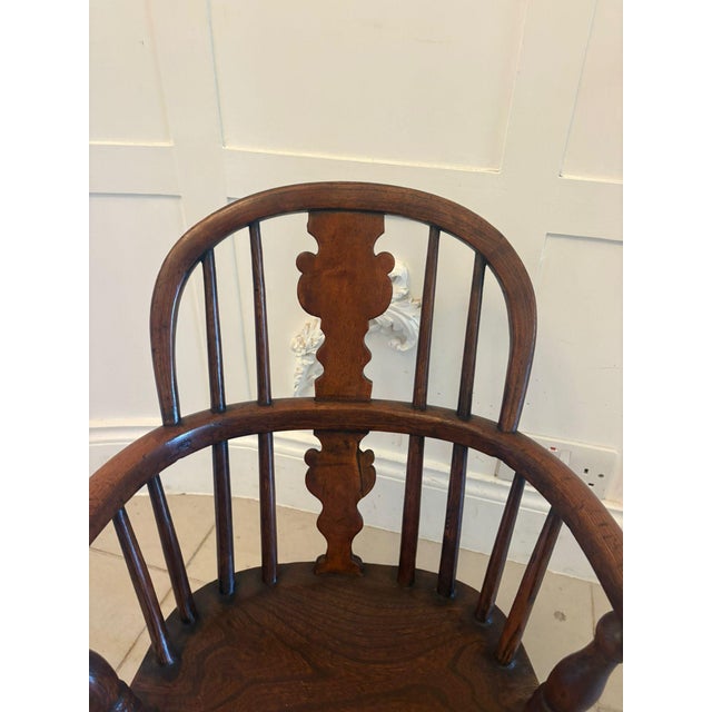 A charming and authentic antique Georgian child’s Windsor chair in solid elm, beautifully made with classic country...