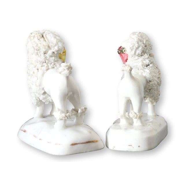 Rare pair of mid-19th century English Staffordshire porcelain lamb figures, each modeled standing with textured woolly...