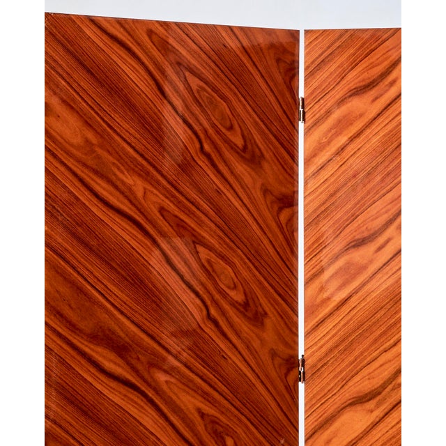 Vintage rosewood folding screen featuring a rich wood grain and four hinged panels. Perfect for adding privacy or dividing...