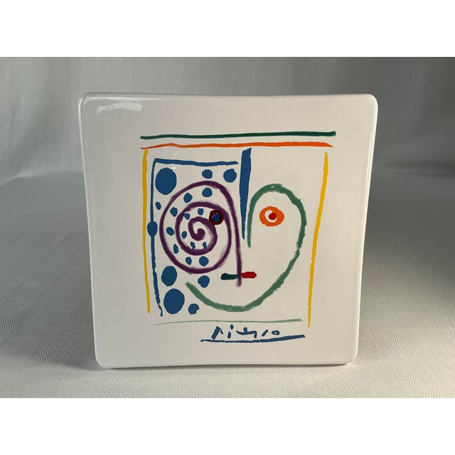 This vintage ceramic plate features a vibrant and iconic design inspired by the works of Pablo Picasso. The plate...