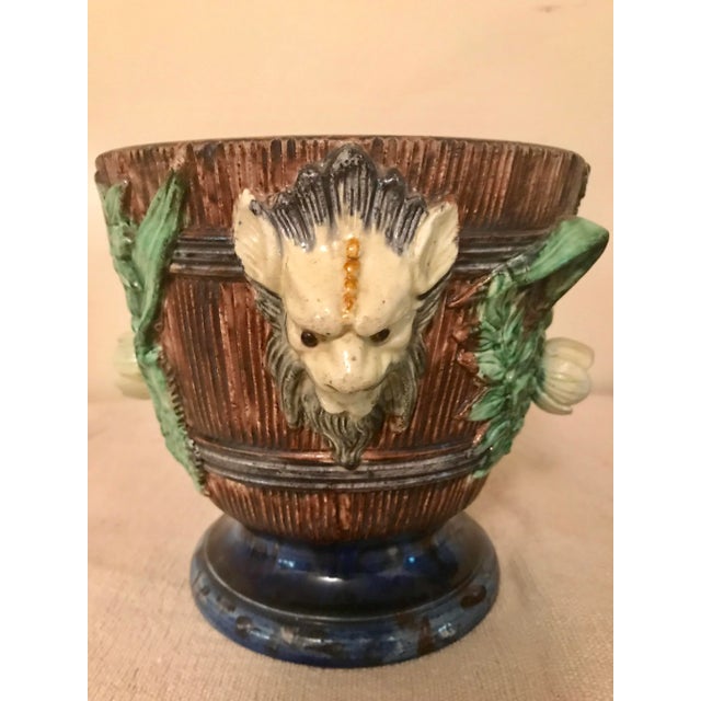 A Pair of 19th Century French Majolica Jardiners with flowers and foliage and mythical creature handles. Circa 1875....
