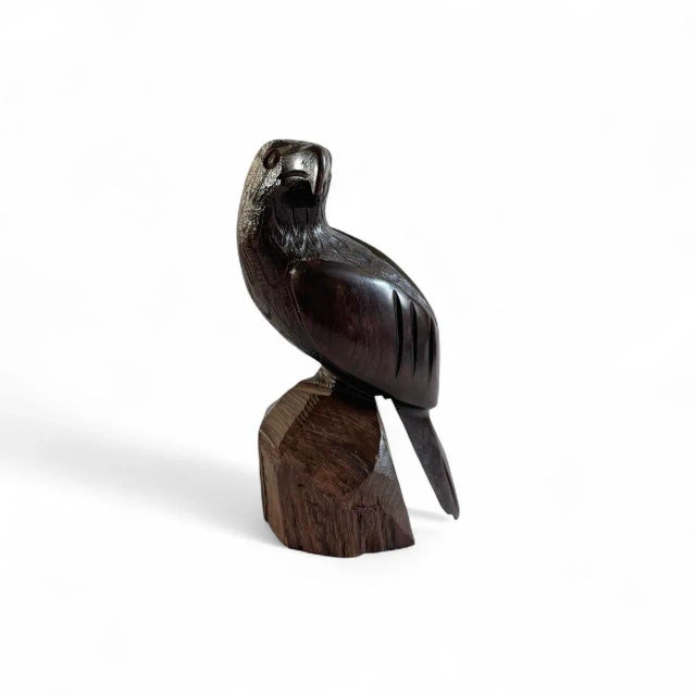 Hand-carved bird sculpture, likely made from a type of hardwood such as ironwood or suar wood, featuring realistic details...