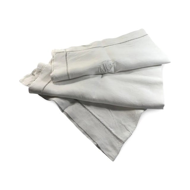 "A lovely example of early 20th-century French needlework, this hand-embroidered cotton pillowcase bears the initials MG...