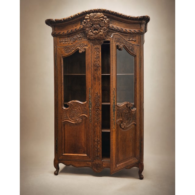 A stunning example of late 19th-century French craftsmanship, this Louis XV Revival armoire showcases richly hand-carved...