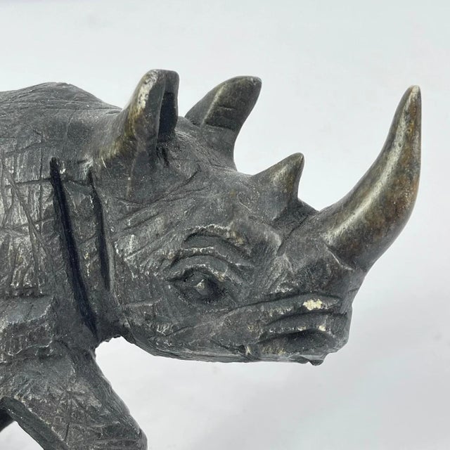 Shona metal rhino sculpture inspired by the well-known Shona artistic tradition of Zimbabwe. While early Shona works were...