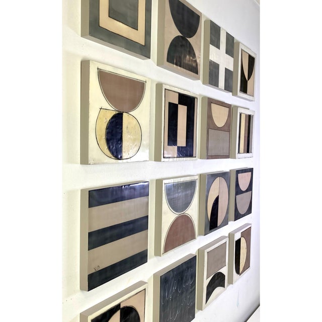 Sixteen 8x8 cradled wood panels make up this encaustic mixed media art piece. In the photo they are hanging spaced...