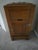 This is an antique wooden icebox is branded The Burns and is crafted from golden oak, likely dating from the late 19th to...