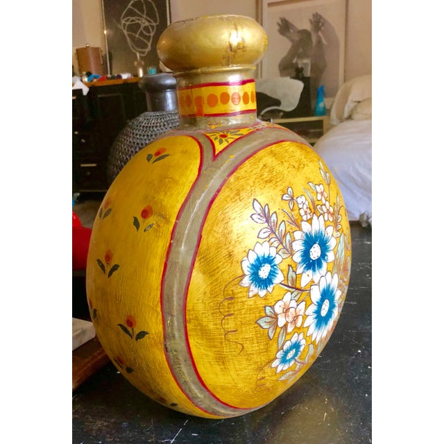 Large tole ware painted urn/vase/vessel from the 1920's. From India. Saffron base color, floral motif.