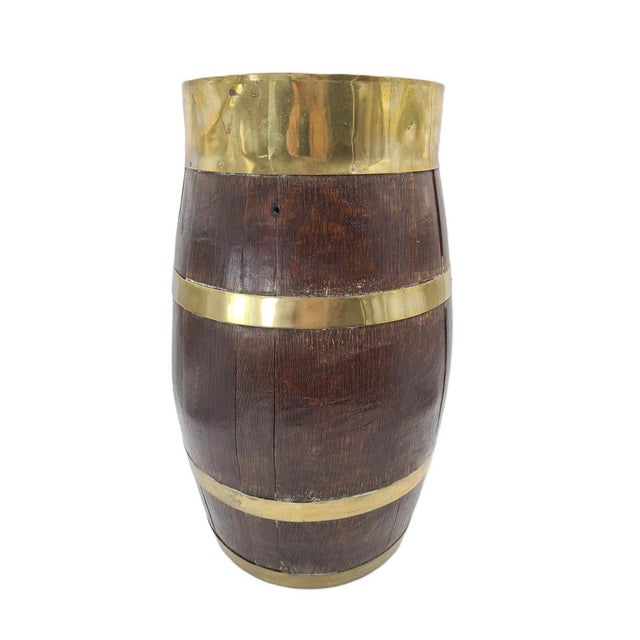 A unique decorative container made of wood and brass in the shape of a classic barrel. It features a very interesting...