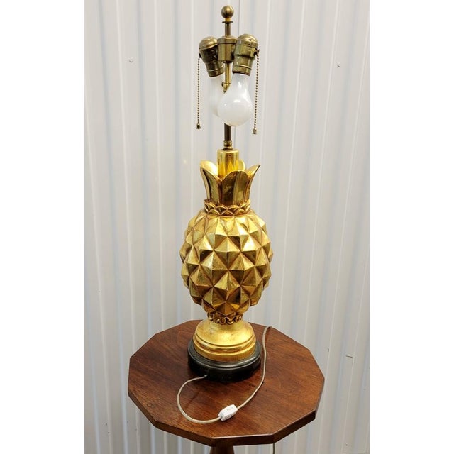 ENTRYWAY COLLECTION - Hollywood Regency Style A Mid-Century Hollywood Regency pineapple table lamp finished in rich gilt,...