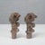 A refined pair of vintage hand-carved wooden ornaments, a testament to fine antique cabinetmaking. The pieces feature a...