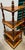 This wooden stand is characterized by its rich, dark-stained wood finish and turned pillar supports, common in mid-20th...