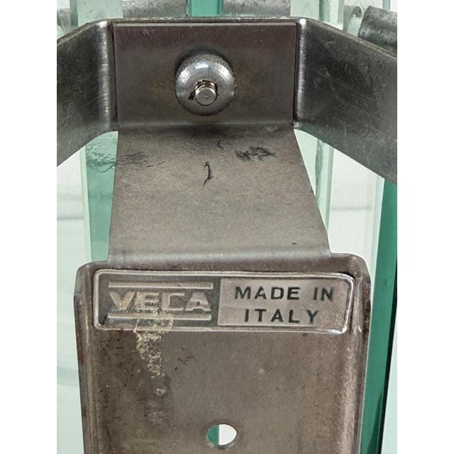 Set of two "Veca" Murano glass wall lamps, made in Italy, 1970s Mark of attribution. Metal frame. Nile green glass. Glass...