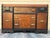 Vintage Art Deco waterfall sideboard or buffet featuring burl wood veneers, black-painted accents, and ornate brass...