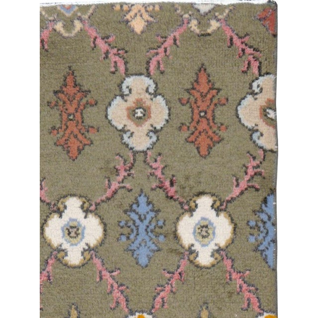 A vintage Turkish Anatolian throw rug. The popular floriated and barbed lattice with rosette bosses takes on an...