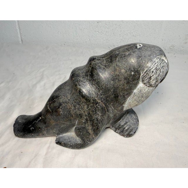 Up for sale is a high quality hand carved antique Canadian Inuit soapstone Eskimo sculpture with disc #1-41858. It's...