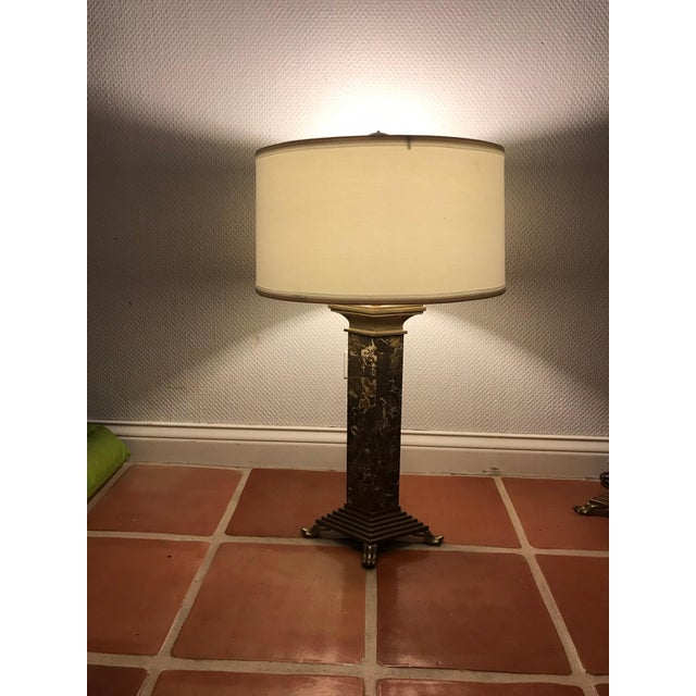 This is a pair of unique shaped marble and brass chapman lamps from 1986.