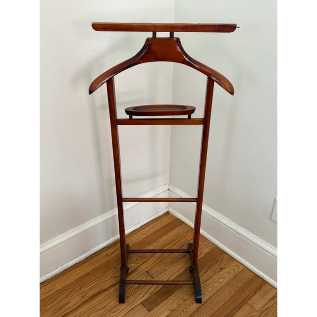 Handsome solid wood gentleman's valet or butler. With shirt grips on top and brass extenders than can be adjusted in or...