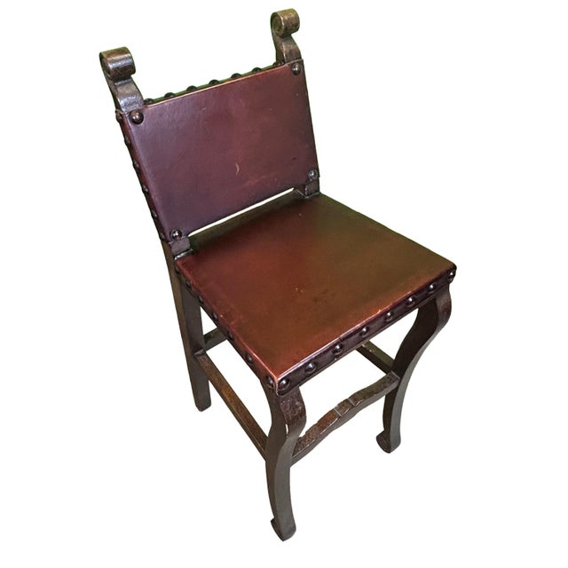 This barstool is designed in the Spanish Colonial Revival (or Hacienda) style. This distinctive aesthetic is defined by...