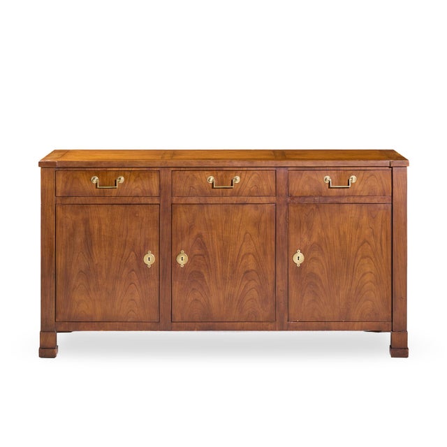 Baker Walnut and Brass Buffet Credenza This credenza measures: 64.25 wide x 19 deep x 34.25 inches high ABOUT PHOTOS: We...