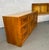 Vintage Lea Furniture faux bamboo credenza features a warm wood laminate finish, central woven-rattan cabinet doors, and...