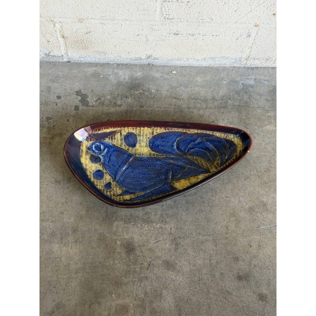 This vintage ceramic dish stands out with an organic elongated triangle form and a shallow basin. The interior features a...
