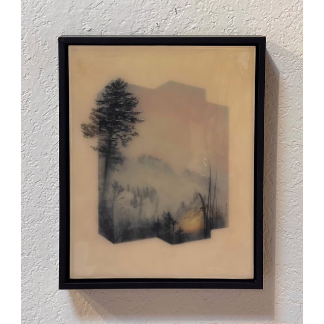 Fire at the Mountain depicts a haunting landscape shrouded in mist, where silhouettes of trees emerge against a backdrop...
