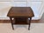 Handsome two-tier side or serving table featuring warm walnut-toned wood and elegant, clean-lined construction. The table...