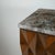 Crafted from ash wood, this cabinet features a front adorned with geometric, diamond-shaped reliefs, lending depth and...