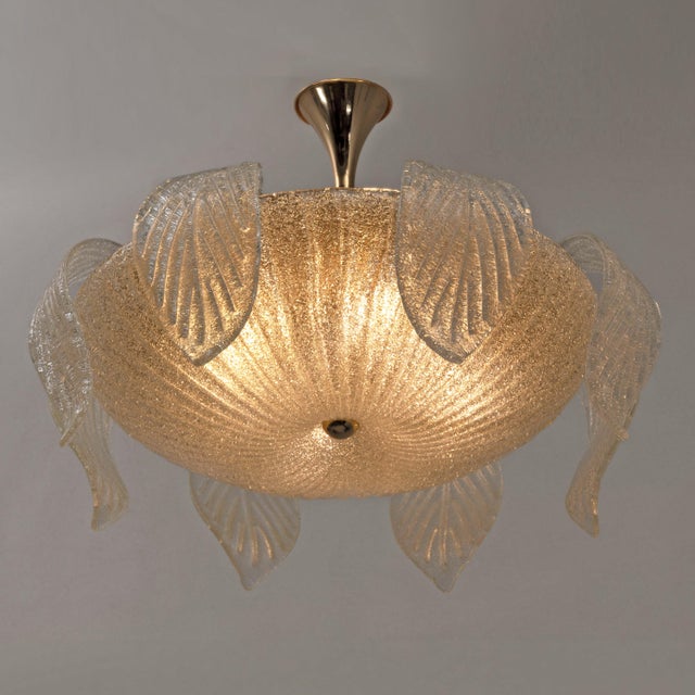 The "Flower" ceiling light is a refined and exclusive piece of Murano craftsmanship by "Vetreria Vistosi." Entirely...