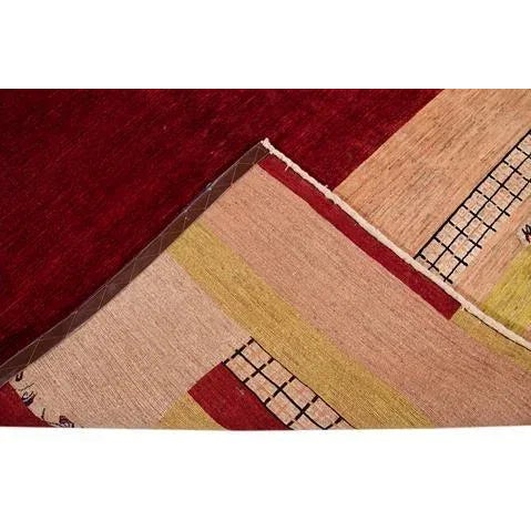 Beautiful Modern Persian Gabbeh hand-knotted wool rug with a red field. This piece has a multi-color accent in an all-over...