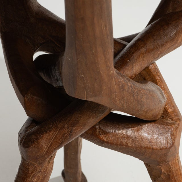 A 20th century coffee table originating from Africa, crafted in carved wood with a circular top supported by a sculptural...