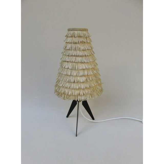 An exceptionally delicate table lamp, manufactured in Austria in the 1950s. The shape of the tripod and the original...