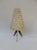 An exceptionally delicate table lamp, manufactured in Austria in the 1950s. The shape of the tripod and the original...