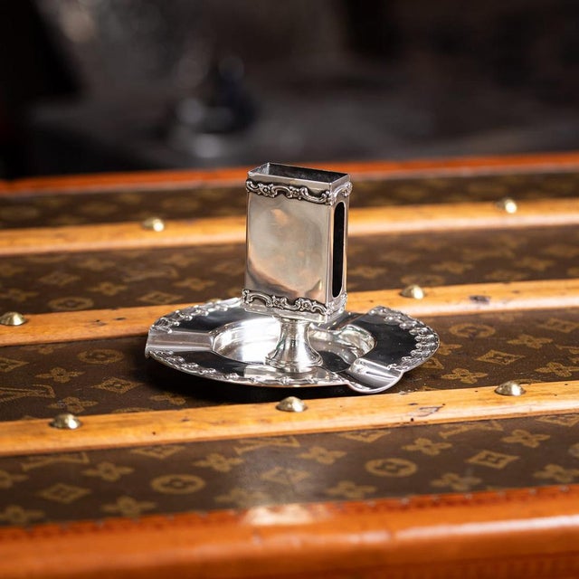Antique 20th Century American solid silver ashtray and matchbox holder by Tiffany & Co. The circular ashtray features...