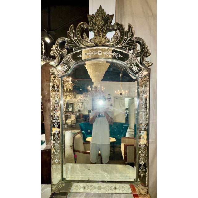The product is an early 20th century Venetian etched mirror, perfect for adding a touch of elegance to any room. This...