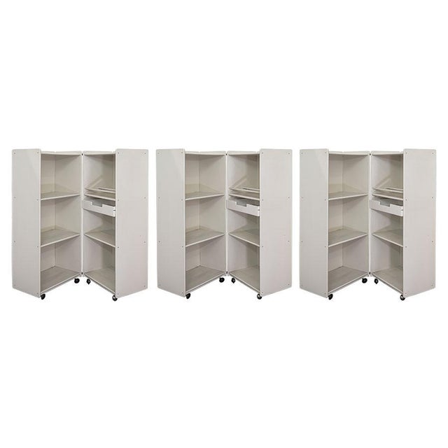 Set of 3 bookcases with wheels in ivory lacquered plywood, great quality and interesting design. Open they measure h 109 x...